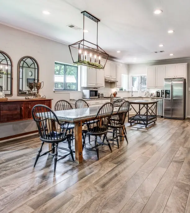 Modern dining room with open kitchen and hard wood floors.